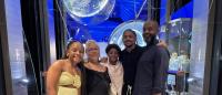 a family standing together at a fancy restaurant